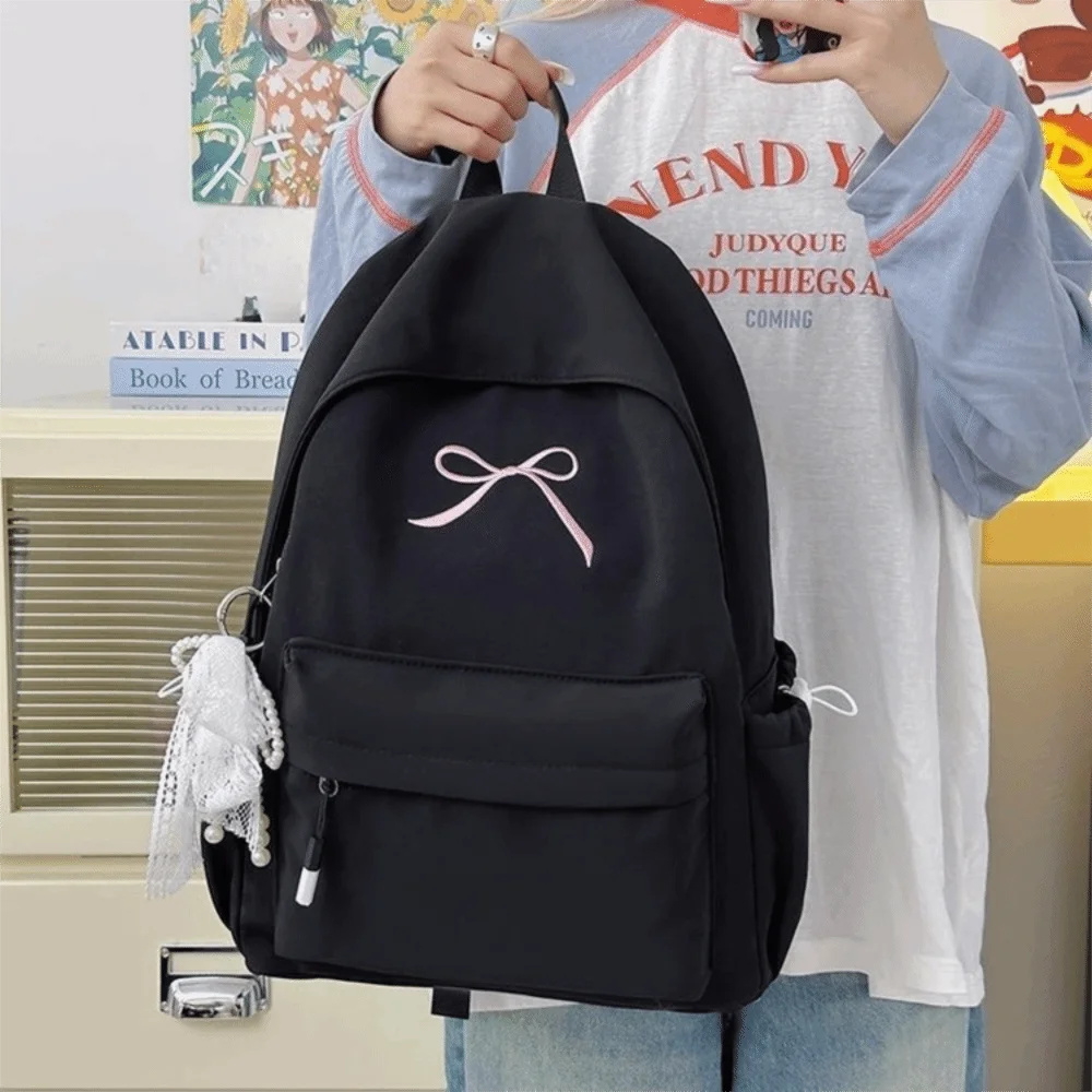 حقيبة ظهر محمولة مطرزة على شكل فيونكة للفتيات من النايلون بلون سادة حقيبة مدرسية للطلاب خفيفة الوزن ذات سعة كبيرة حقيبة ظهر للسفر