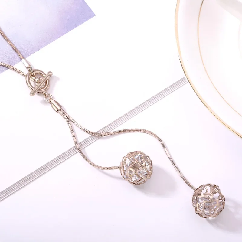 

2025 Tassel small ball T-buckle long necklace, a fashionable and versatile women's sweater chain