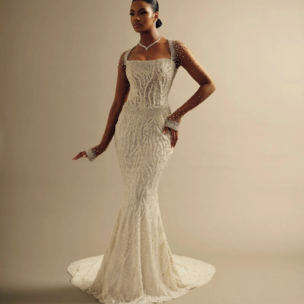 新しい取り外し可能なトレーン付きクリスタルウェディングドレス、まばゆいビーズ刺繍のロングスリーブブライダルガウン、カスタマイズされた絶妙な花嫁用ドレス