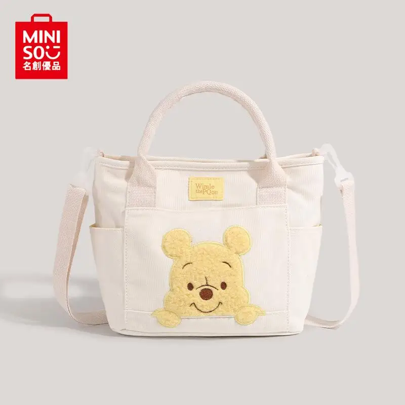 

2024 new MINISO cute cartoon Winnie the Pooh canvas messenger bag doll portable portable messenger bag dual-use bag