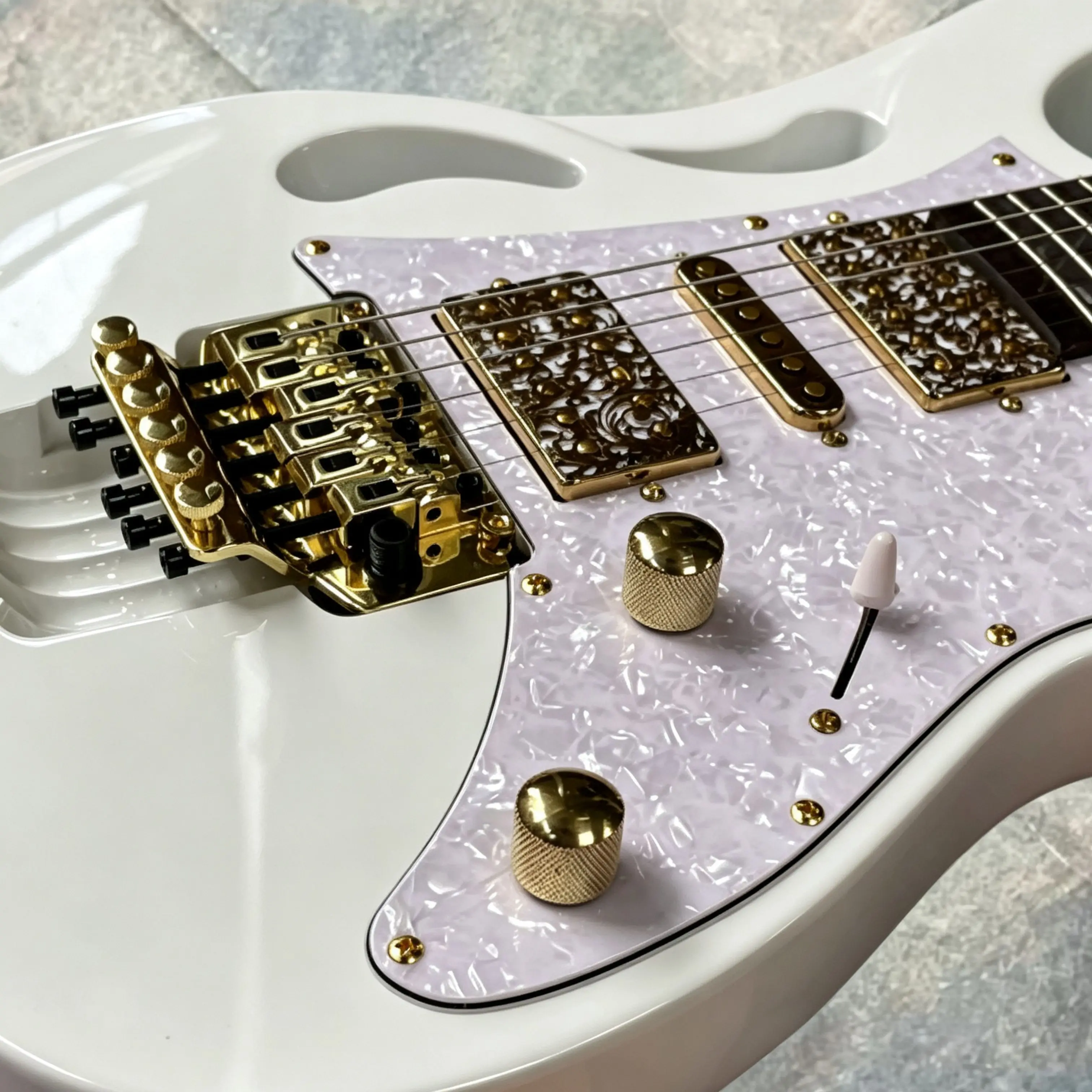 White Openwork-body electric guitar,gold inlay HSH pickups, white pearl pickguard guitars, Vibrato system guitarra
