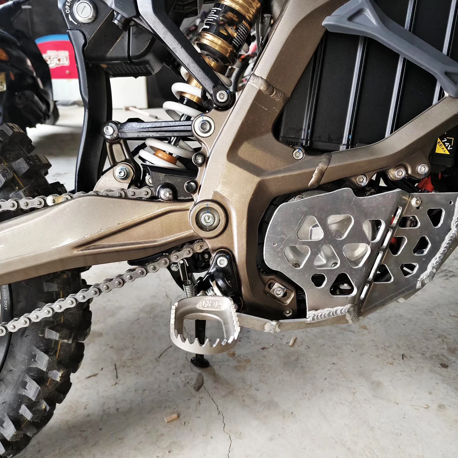 

Super ebike Ultra Bee Modified Extended and Widened Footpegs Lowered Rearward-Shifted Forward-Tilted Ultra Bee Steel Footpegs.