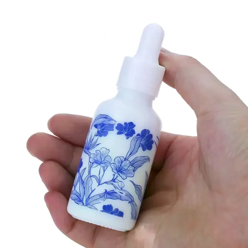White Floral Print Glass Essential Oil Dropper Bottles With Leak Proof Lids Perfect For Aromatherapy Storing Skincare Blue