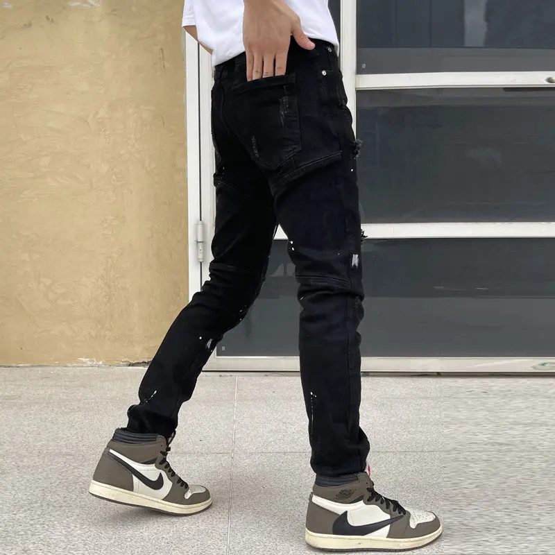 Jeans da uomo di moda di strada Jeans strappati dipinti Slim Fit elasticizzati neri da uomo che bordano pantaloni di Jeans elastici Hip Hop di design Patched