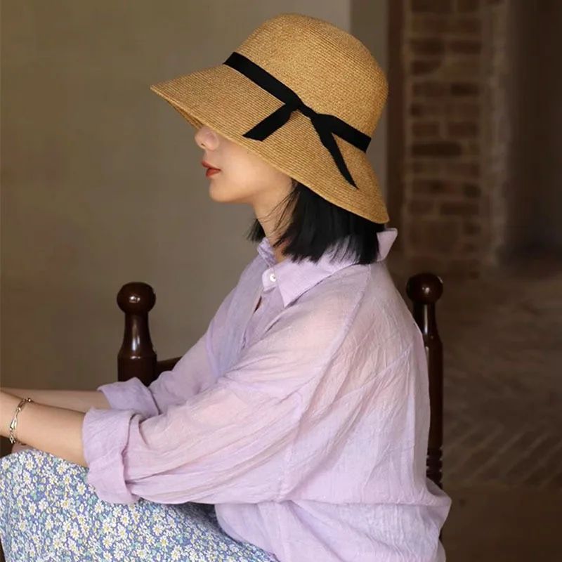 

Designer fine grass woven straw hat female bow sun hat seaside holiday fisherman hat foldable Joker travel.