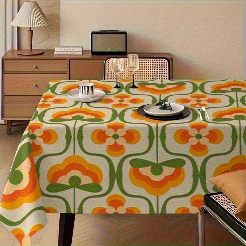 One vintage 1970s tablecloth featuring a bold orange and green floral pattern.