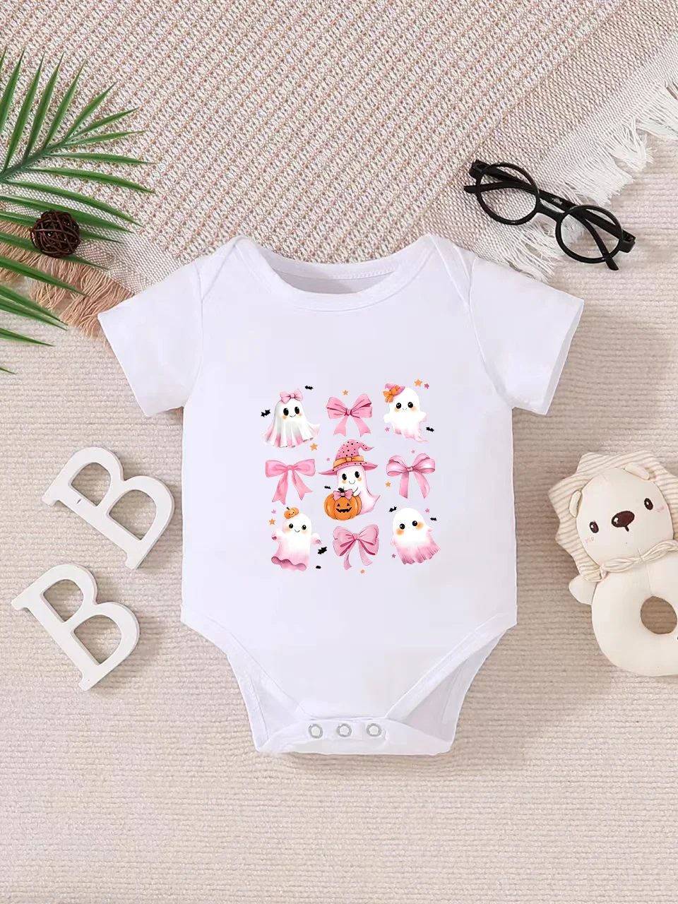 Playful letter-printed baby short-sleeve triangle bodysuit. Button closure for easy dressing, machine washable