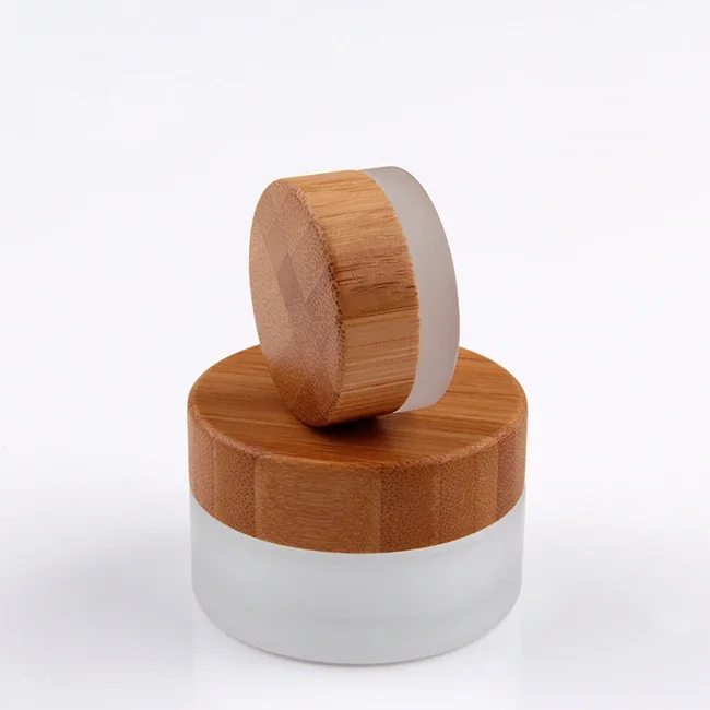 

whosesale high quality skin care/cosmetic/face/body Butter cream container clear frosted glass jar with bamboo wooden caps