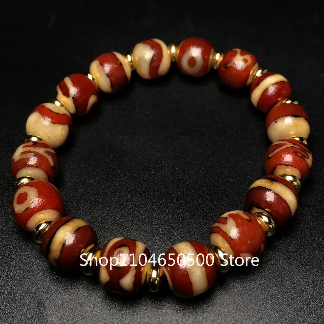

Tibetan red meat god of wealth noble tiger teeth three eyes first-line agate bucket dzi beads bracelet pendant Duobao string par