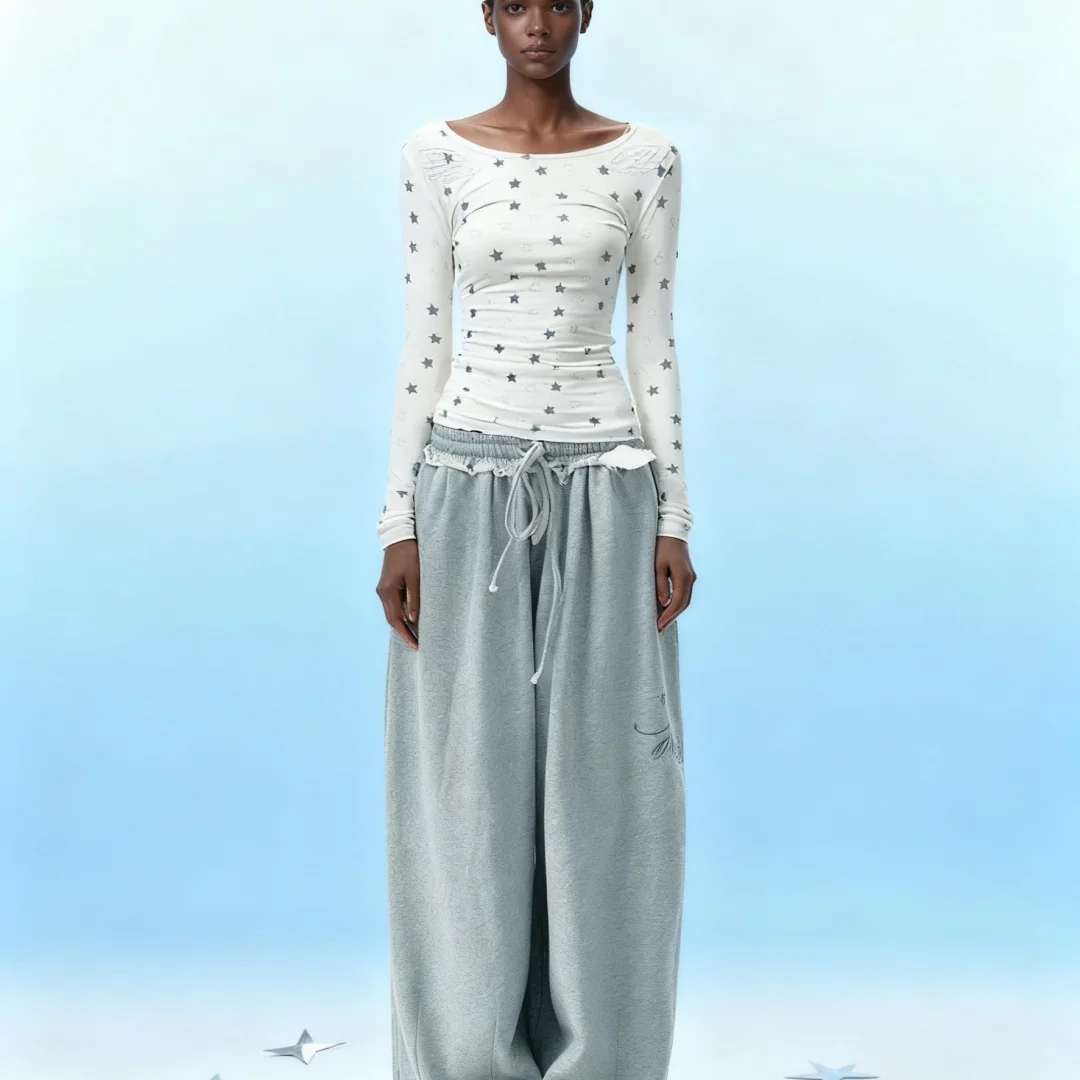 

Women Long Sleeve Tee Features All Over Star Patterns and Delicate Embroidered Wings