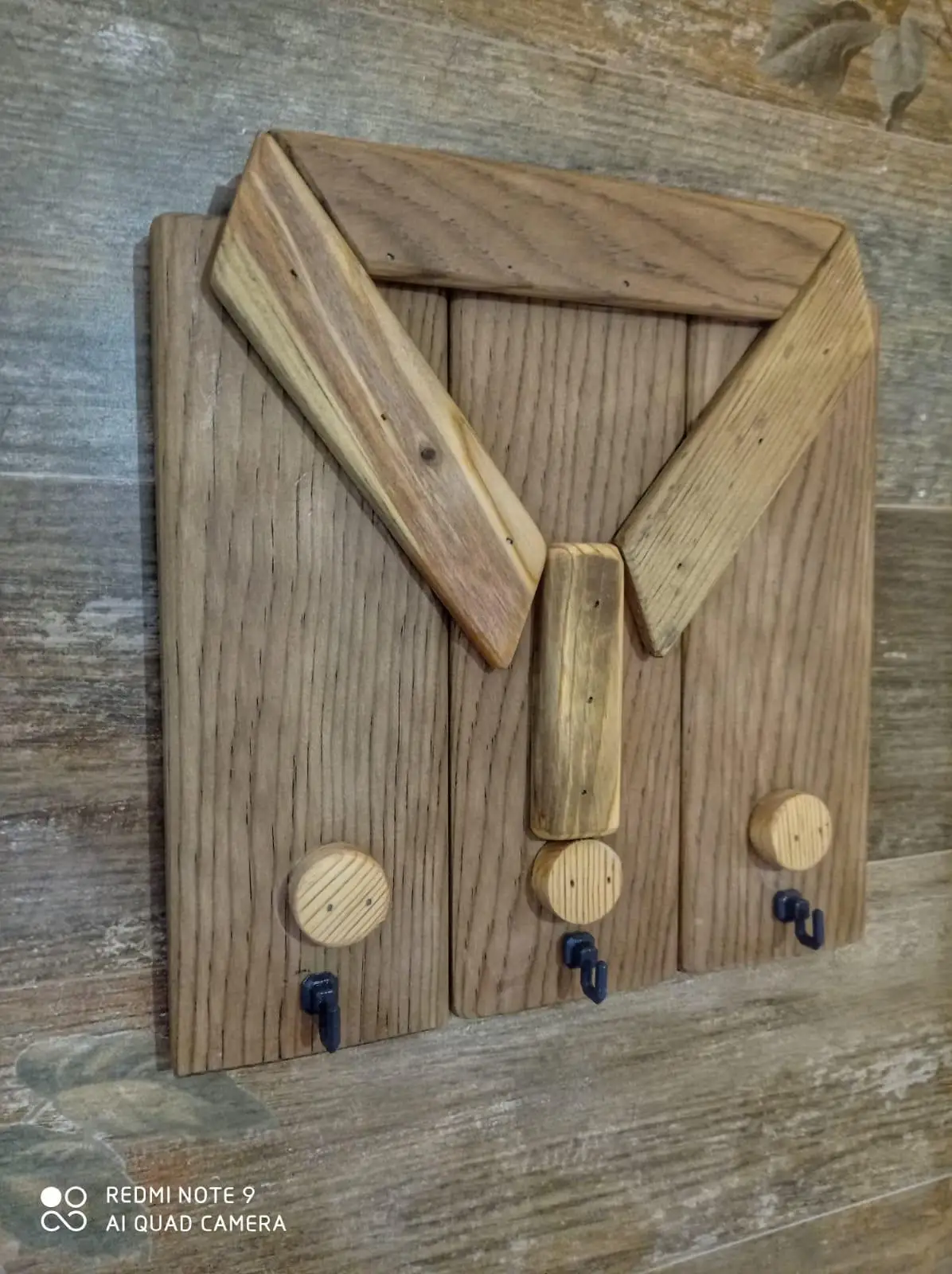 Wooden key chain with a shirt pattern.