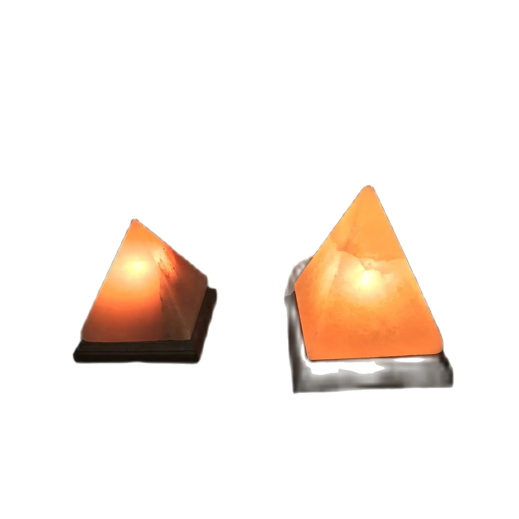 Himalayan salt lamp with pyramid shape made of polished rock and carved machine with approximate sizes of 17 cm per side with included and approved bulb and cable