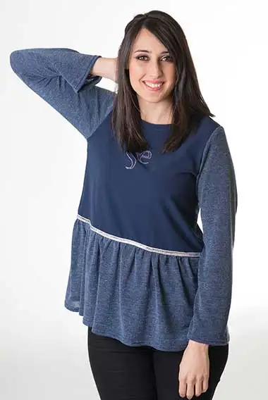 Women's knitted sweater in elegant blue, knitted sweater in blue, adorned with a wool ruffle and a silver sequin trim. Perfect to add a chic touch to your look.